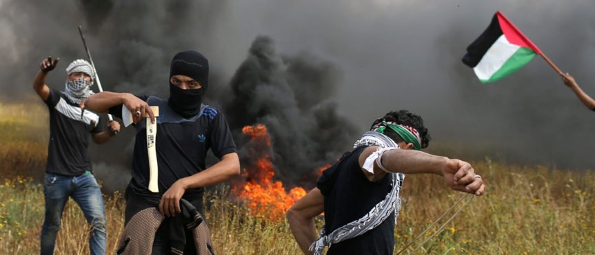A Palestinian demonstrator holds an axe during clashes with Israeli troops