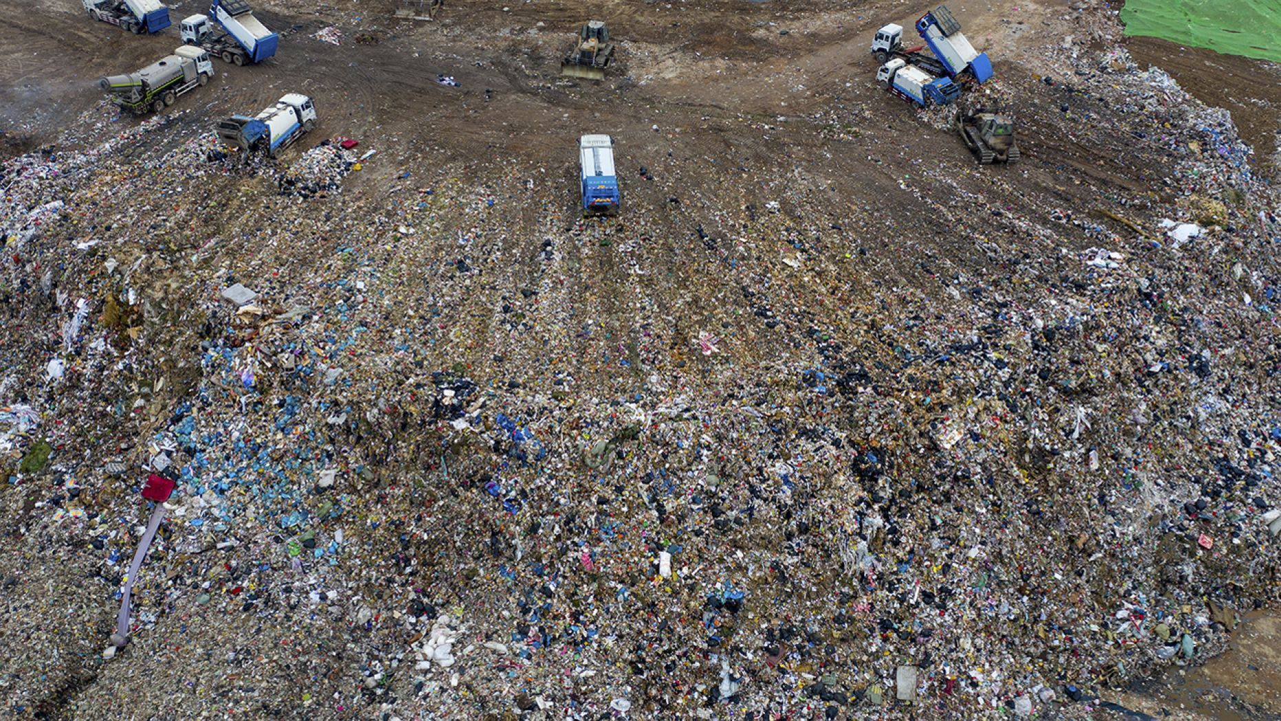 Chinese workers sort out and bury kitchen waste at the Jiangcungou Landfill, which is the China's largest refuse landfill, in Xi'an city, northwest China's Shaanxi province, 21 August 2019.