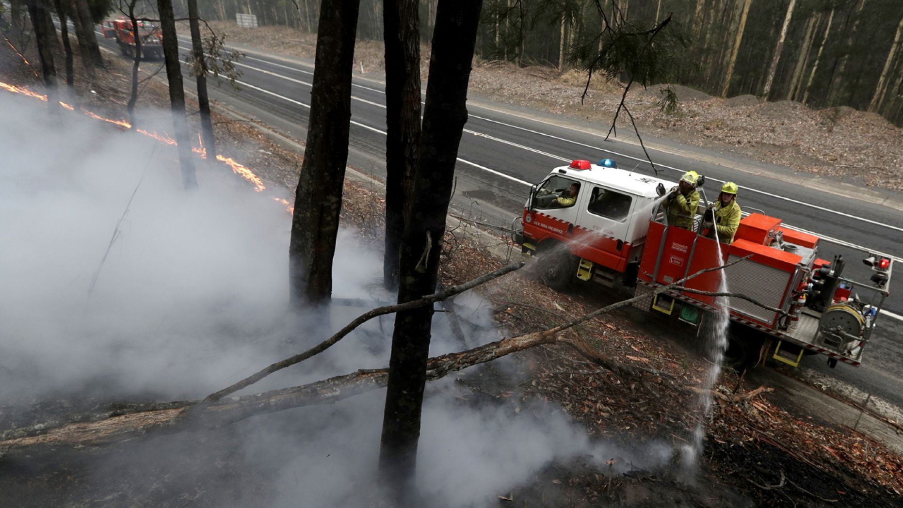 Firefighters manage a controlled burn to help contain a larger fire near Falls Creek, Australia, Sunday, Jan. 5, 2020. 