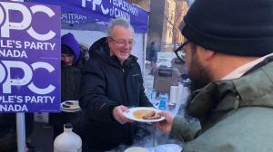 Randy Hillier seen in a Feb. 13, 2022, photo on Wellington street in Ottawa, Canada, holding a pancake breakfast for those participating in the Freedom Convoy protest.  (Randy Hillier/Facebook )