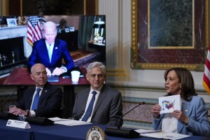 Vice President Kamala Harris (right) holds up a map depicting abortion access by state during the first meeting of the interagency Task Force on Reproductive Health on Aug. 3, 2022. | Susan Walsh/AP Photo