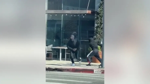 Two alleged assailants running away after robbing a Rolex in Los Angeles, CA. (Credit: LAPD) (Los Angeles Police Department)